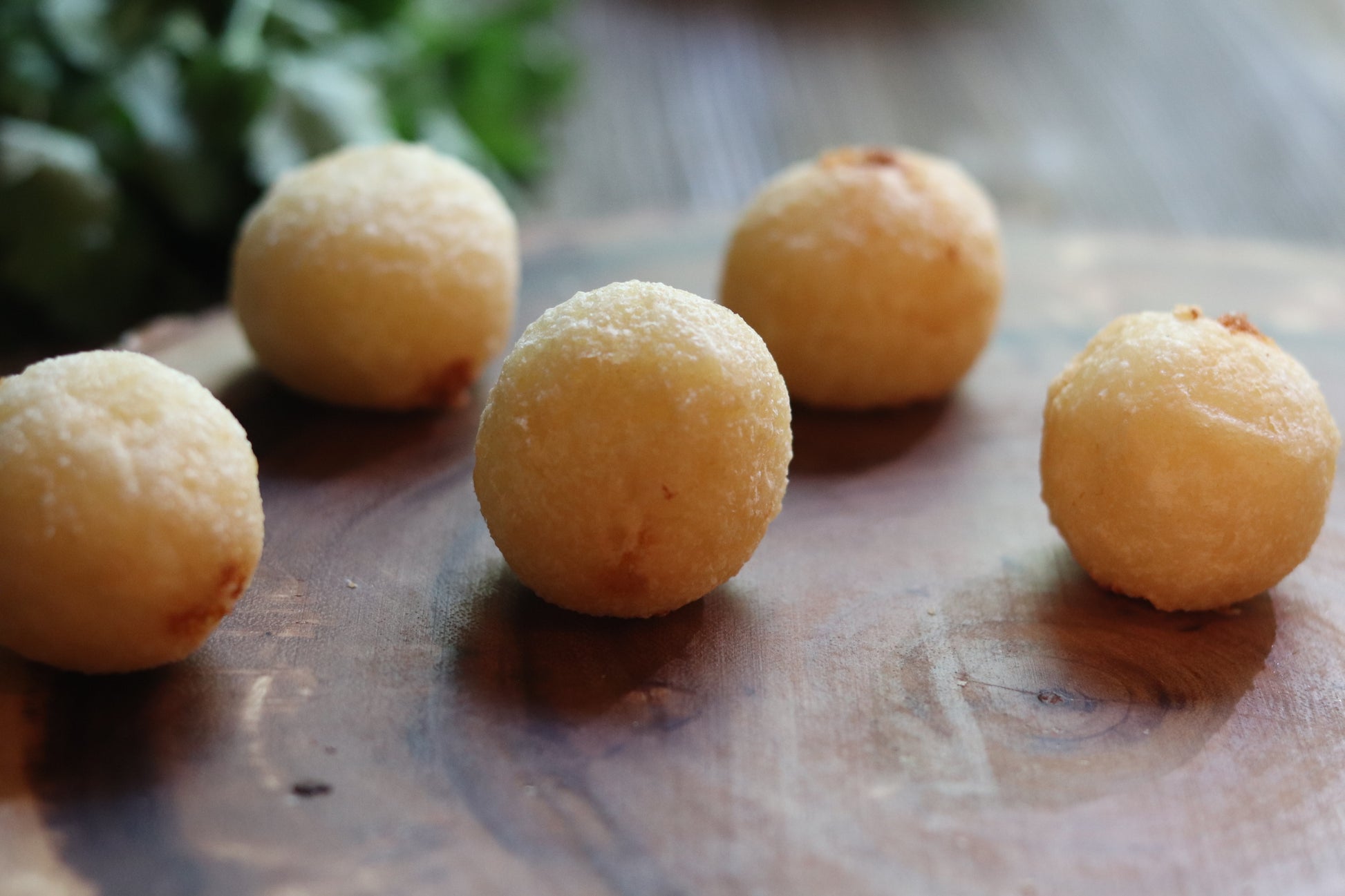 Cheese Yuca Bites in little balls served on a wooden platter. Super yummy cheese snack.